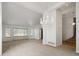 Spacious living room with neutral carpeting, a chandelier, and lots of windows to bring in natural light at 9174 Lark Sparrow Pl, Highlands Ranch, CO 80126