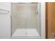 Bathroom shower featuring a glass enclosure with tile surround and shower head at 9174 Lark Sparrow Pl, Highlands Ranch, CO 80126