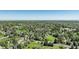 Expansive aerial view of a tree-lined residential area with green spaces and a clear blue sky at 291 W Sycamore Ln, Louisville, CO 80027