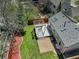 Aerial view of a backyard with a wooden deck, pergola, green lawn, and privacy fence at 291 W Sycamore Ln, Louisville, CO 80027