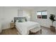 Bright bedroom with hardwood floors, bench and window at 291 W Sycamore Ln, Louisville, CO 80027