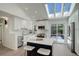Open kitchen with stainless steel appliances, white cabinets, and a large island with seating at 291 W Sycamore Ln, Louisville, CO 80027