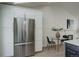 Bright kitchen features stainless steel refrigerator, white cabinets, and adjacent breakfast nook at 291 W Sycamore Ln, Louisville, CO 80027