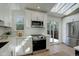 Bright kitchen with stainless steel appliances, white cabinets, and skylights at 291 W Sycamore Ln, Louisville, CO 80027
