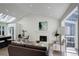 Bright living room with a fireplace, vaulted ceilings, and natural light from a skylight at 291 W Sycamore Ln, Louisville, CO 80027