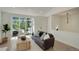 Cozy living room featuring a tufted sofa, large windows, and modern decor at 291 W Sycamore Ln, Louisville, CO 80027