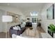 Open floor plan connecting the living room and kitchen with skylights and neutral decor at 291 W Sycamore Ln, Louisville, CO 80027