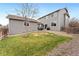 A spacious backyard with a combination of grass, rock features, and patio seating offers plenty of space at 11022 Newark St, Commerce City, CO 80640