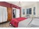 Bright bedroom featuring a decorative wardrobe, a comfortable bed, and an adjacent seating area at 11022 Newark St, Commerce City, CO 80640