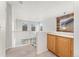 Bright hallway with staircase, built-in cabinets, and a window with wood trim detail, offering natural light and storage at 11022 Newark St, Commerce City, CO 80640
