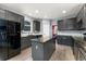Well-equipped kitchen with dark cabinets, stainless steel appliances, granite countertops, and ample storage space at 11022 Newark St, Commerce City, CO 80640