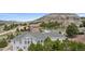 Elevated view of an upscale community, featuring well-maintained homes and landscaped yards, nestled among mature trees at 1553 Plowman Dr, Monument, CO 80132