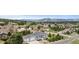 A scenic aerial view of a residential area with well-maintained homes, lush trees, and mountain views on a sunny day at 1553 Plowman Dr, Monument, CO 80132