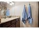Elegant bathroom with a granite countertop, dark wood cabinets, and a shower with a glass enclosure at 1553 Plowman Dr, Monument, CO 80132