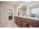 Luxurious bathroom featuring double vanity with granite counters, tile floors, and a separate glass shower and tub at 1553 Plowman Dr, Monument, CO 80132