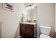 Cozy powder room with granite countertop and classic dark wood vanity at 1553 Plowman Dr, Monument, CO 80132