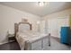 Comfortable bedroom with a cushioned headboard, soft natural lighting, and a closet for easy storage at 1553 Plowman Dr, Monument, CO 80132