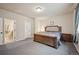 Comfortable bedroom with a cushioned headboard, soft natural lighting, and an ensuite bathroom at 1553 Plowman Dr, Monument, CO 80132