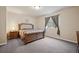 Comfortable bedroom with a cushioned headboard, soft natural lighting, and a beautiful view of the outdoors at 1553 Plowman Dr, Monument, CO 80132