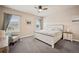 Cozy bedroom with a full-sized bed, ceiling fan, and natural light from the windows at 1553 Plowman Dr, Monument, CO 80132