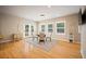 Sun-filled dining area features hardwood floors, large windows, and a glass table with seating for four at 1553 Plowman Dr, Monument, CO 80132