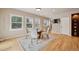Bright dining room with hardwood floors, large windows, a glass table with seating for four, and a built-in hutch at 1553 Plowman Dr, Monument, CO 80132
