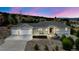 Charming home featuring a two-car garage, landscaped front yard, and inviting entrance under a beautiful evening sky at 1553 Plowman Dr, Monument, CO 80132