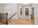 Inviting foyer featuring hardwood floors, a stylish entryway table, and a charming wood door with frosted windows at 1553 Plowman Dr, Monument, CO 80132