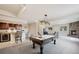 Open basement game room featuring a pool table, bar area, and fireplace at 1553 Plowman Dr, Monument, CO 80132