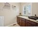 Practical laundry space with granite counters, abundant storage, and window with shutters at 1553 Plowman Dr, Monument, CO 80132