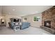 Inviting living room with a cozy stone fireplace and ample seating at 1553 Plowman Dr, Monument, CO 80132