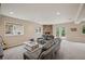 Bright living room with a stone fireplace, neutral carpet, and door to the patio at 1553 Plowman Dr, Monument, CO 80132