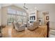 Bright living room featuring high ceilings, large windows, a cozy fireplace, and comfortable seating at 1553 Plowman Dr, Monument, CO 80132