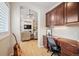 Hallway with built-in dark wood cabinets and desk leading to a spacious living room at 1553 Plowman Dr, Monument, CO 80132
