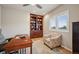 Comfortable home office offers a built-in bookcase, a large window, and a cozy chair at 1553 Plowman Dr, Monument, CO 80132