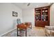 Functional home office boasts a wooden desk, a built-in bookcase, and ample lighting for productivity at 1553 Plowman Dr, Monument, CO 80132