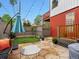 Cozy backyard space with stone patio, artificial grass area, and string lights at 2524 Champa St # 1, Denver, CO 80205