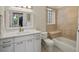 Bright bathroom featuring tiled shower and tub, modern vanity with ample storage, and neutral décor at 2524 Champa St # 1, Denver, CO 80205