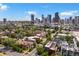 Scenic view showcasing the Denver skyline, lush green trees and neighborhood architecture at 2524 Champa St # 1, Denver, CO 80205