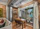 Cozy dining area with exposed brick and a large window offering natural light and outdoor views at 2524 Champa St # 1, Denver, CO 80205