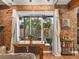Charming dining area with exposed brick, natural light, and views of the landscaped backyard at 2524 Champa St # 1, Denver, CO 80205