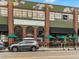 The Denver Central Market features an inviting exterior and outdoor seating with green umbrellas at 2524 Champa St # 1, Denver, CO 80205