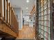 Hallway featuring wooden staircase and unique architectural details and transition to kitchen at 2524 Champa St # 1, Denver, CO 80205