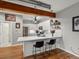 Modern kitchen with stainless steel appliances, white cabinetry, and bar seating at 2524 Champa St # 1, Denver, CO 80205
