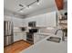 Stylish kitchen with stainless steel appliances, sleek white cabinets, and modern lighting fixtures at 2524 Champa St # 1, Denver, CO 80205