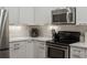Well-equipped kitchen featuring stainless steel appliances, quartz countertops, and ample cabinet space at 2524 Champa St # 1, Denver, CO 80205