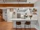 Modern kitchen with stainless steel appliances, white cabinetry, and breakfast bar seating at 2524 Champa St # 1, Denver, CO 80205