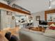 Modern living room featuring exposed brick, open floor plan to kitchen, and hardwood floors at 2524 Champa St # 1, Denver, CO 80205