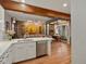 Open-concept living space featuring kitchen with island, exposed brick, and comfortable seating area at 2524 Champa St # 1, Denver, CO 80205
