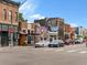 Charming streetscape with a variety of businesses and colorful murals under a clear blue sky at 2524 Champa St # 1, Denver, CO 80205